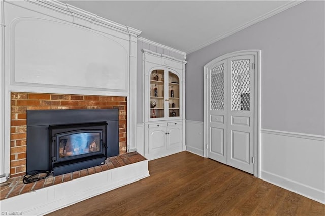 unfurnished living room with crown molding and dark hardwood / wood-style flooring