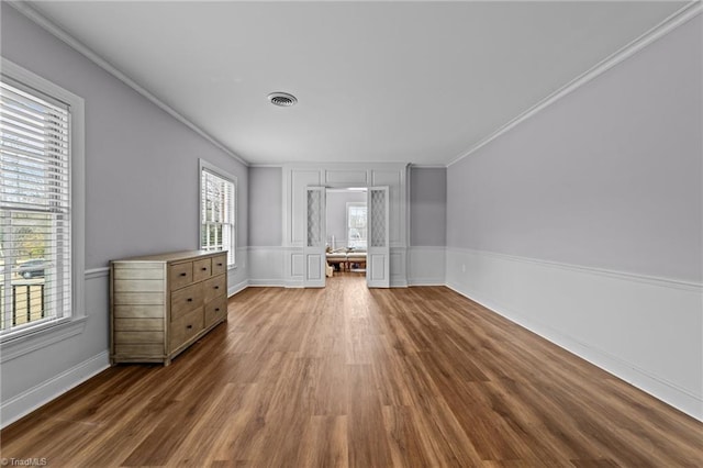 unfurnished bedroom featuring ornamental molding and dark wood-type flooring