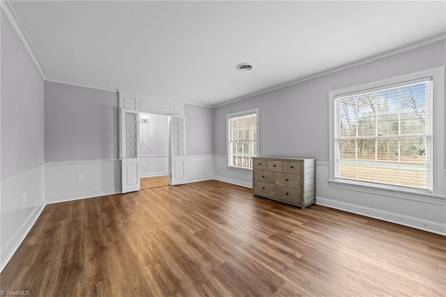 unfurnished bedroom featuring crown molding and hardwood / wood-style floors