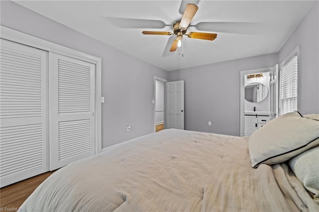 bedroom with ceiling fan, wood-type flooring, and a closet