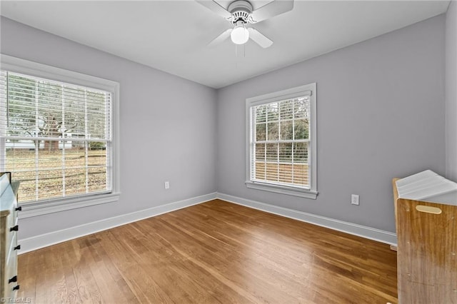 empty room with hardwood / wood-style flooring and ceiling fan