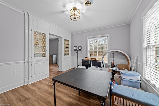 home office with ornamental molding and hardwood / wood-style floors