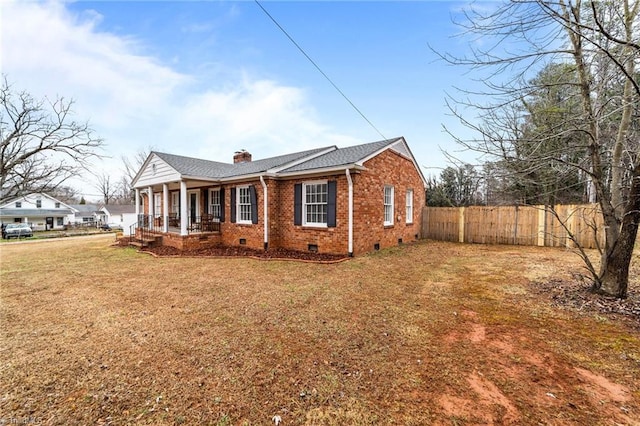 view of home's exterior featuring a lawn and covered porch