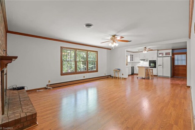938 Croyden St, High Point, NC 27262 - unfurnished living room featuring a baseboard radiator, a ceiling fan, light wood finished floors, ornamental molding, and baseboards