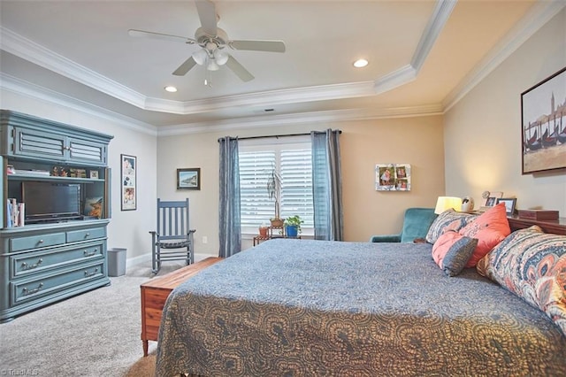 carpeted bedroom featuring recessed lighting, baseboards, a tray ceiling, and ornamental molding