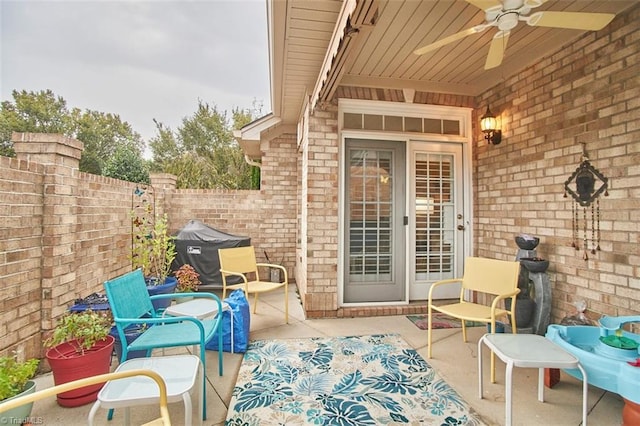 view of patio with an outdoor living space, ceiling fan, and fence