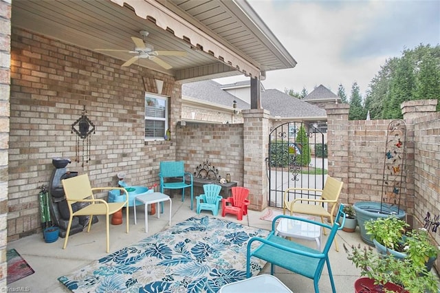 view of patio / terrace featuring a gate, ceiling fan, and fence