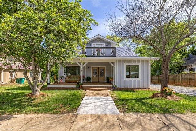 225 Main St E, Pilot Mountain, NC 27041 - view of front of house with a porch, board and batten siding, a balcony, and french doors