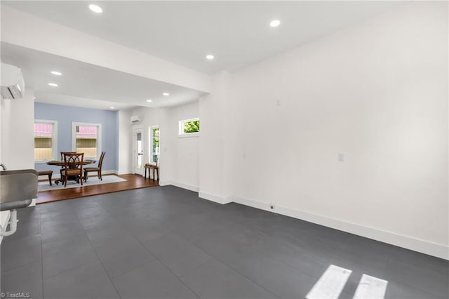 225 Main St E, Pilot Mountain, NC 27041 - living area with a wall unit AC, recessed lighting, and baseboards