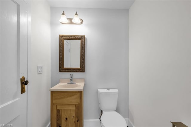 225 Main St E, Pilot Mountain, NC 27041 - bathroom featuring toilet, vanity, and baseboards