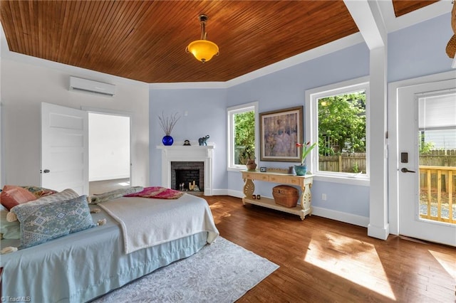225 Main St E, Pilot Mountain, NC 27041 - bedroom with wood ceiling, a wall mounted AC, multiple windows, wood finished floors, and a brick fireplace
