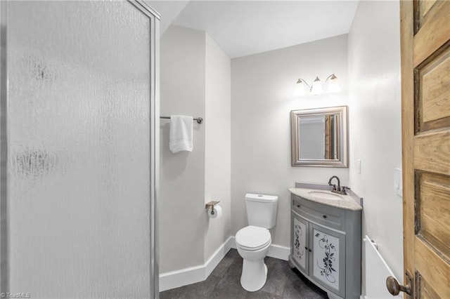 225 Main St E, Pilot Mountain, NC 27041 - bathroom featuring vanity, a stall shower, toilet, baseboards, and tile patterned flooring