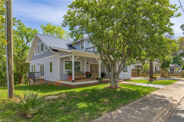 225 Main St E, Pilot Mountain, NC 27041 - view of front of property featuring board and batten siding, a porch, french doors, and metal roof