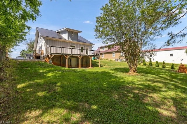 225 Main St E, Pilot Mountain, NC 27041 - back of property with a wooden deck, a lawn, and board and batten siding