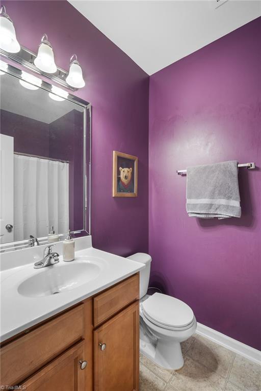 5430 Forester Dr, High Point, NC 27265 - full bath with vanity, tile patterned floors, and a shower with shower curtain