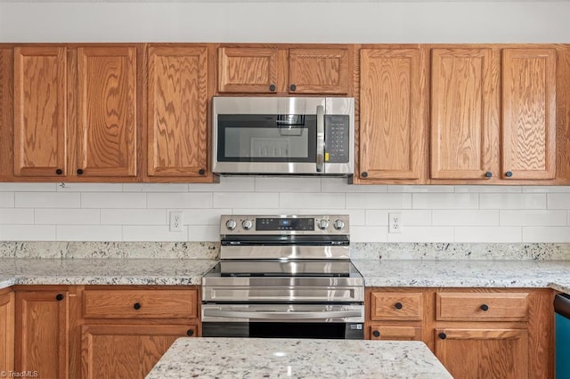 305 Apple Ridge Rd, Greensboro, NC 27406 - kitchen featuring stainless steel appliances, backsplash, and brown cabinetry