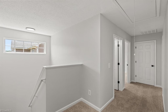305 Apple Ridge Rd, Greensboro, NC 27406 - corridor featuring attic access, an upstairs landing, carpet floors, and a textured ceiling