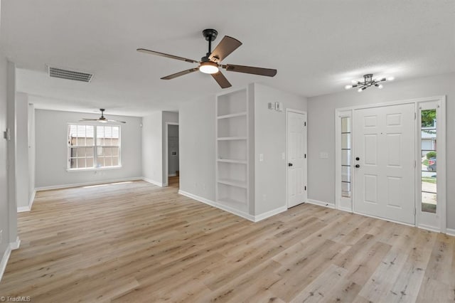 305 Apple Ridge Rd, Greensboro, NC 27406 - entryway featuring light wood-type flooring, a ceiling fan, and a chandelier