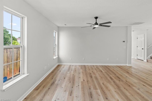 305 Apple Ridge Rd, Greensboro, NC 27406 - empty room featuring a ceiling fan, light wood-style floors, and stairs