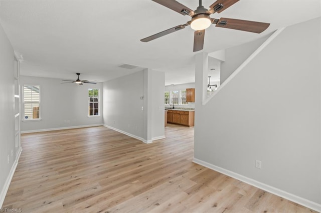 305 Apple Ridge Rd, Greensboro, NC 27406 - unfurnished living room with a ceiling fan, healthy amount of natural light, and light wood-style floors