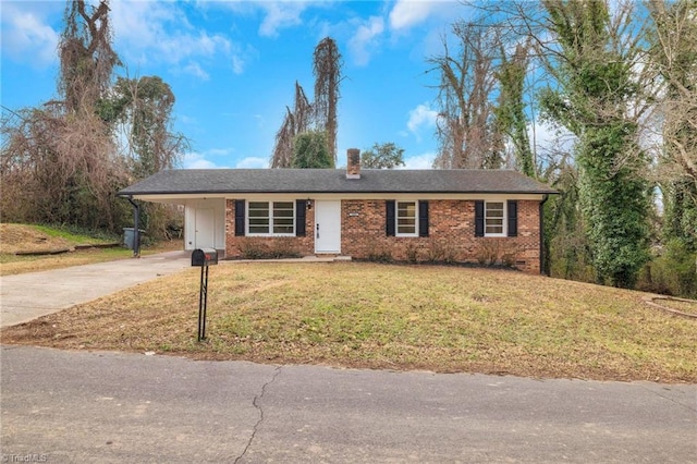 ranch-style house featuring concrete driveway, a chimney, a front lawn, a carport, and brick siding