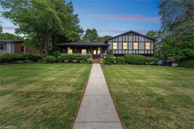 view of front of home with a lawn and covered porch