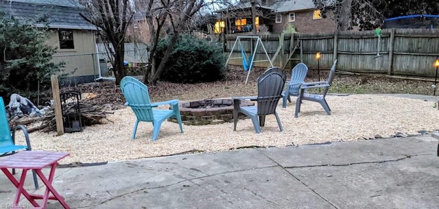 fenced backyard featuring a fire pit and a patio area