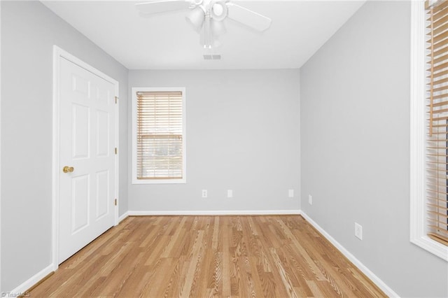 empty room with light hardwood / wood-style floors and ceiling fan