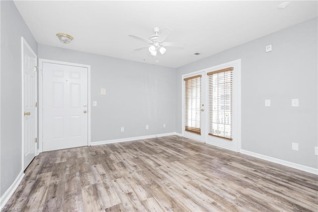 spare room featuring ceiling fan and light wood-type flooring