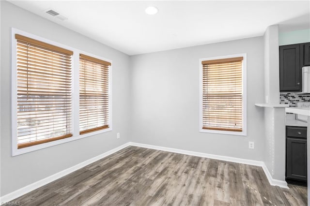 unfurnished dining area with hardwood / wood-style flooring and a wealth of natural light