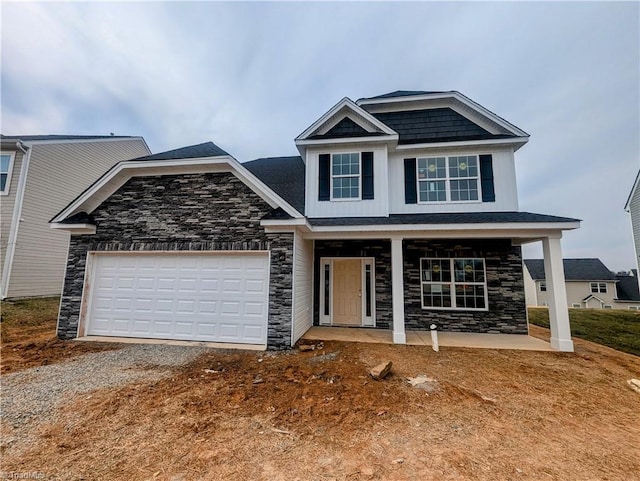 750 Palomino Mustang Dr Unit 692, Whitsett, NC 27377 - craftsman inspired home with stone siding, covered porch, an attached garage, and driveway