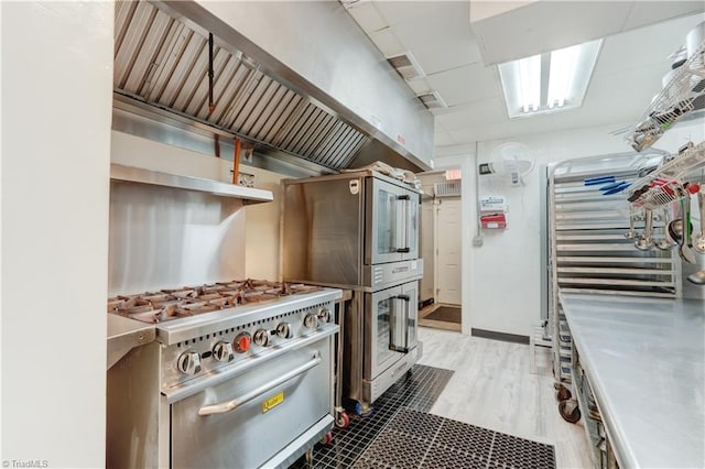 17 E Main St, Thomasville, NC 27360 - kitchen with stove, custom range hood, stainless steel countertops, and wood finished floors