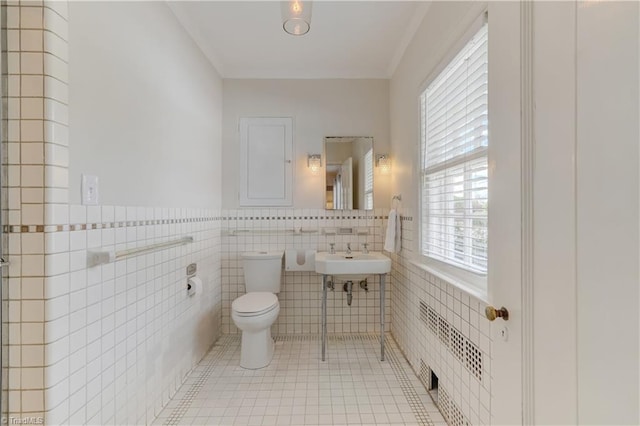 17 E Main St, Thomasville, NC 27360 - bathroom featuring tile walls, wainscoting, tile patterned flooring, and ornamental molding