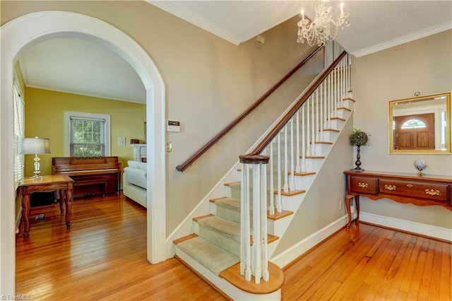 17 E Main St, Thomasville, NC 27360 - staircase with arched walkways, wood-type flooring, crown molding, and a chandelier