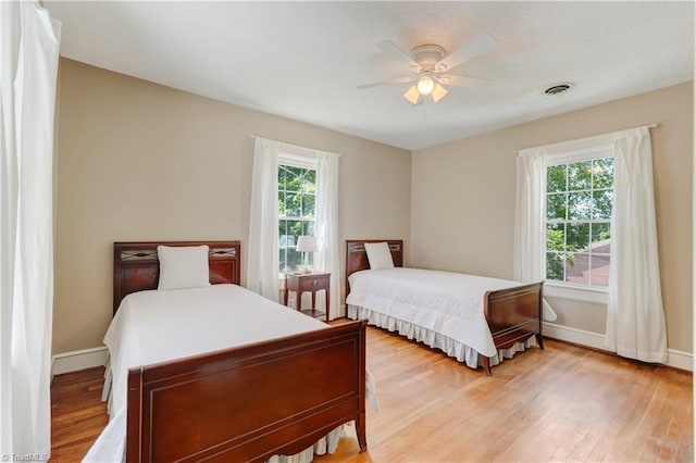 17 E Main St, Thomasville, NC 27360 - bedroom with multiple windows, light wood finished floors, and ceiling fan