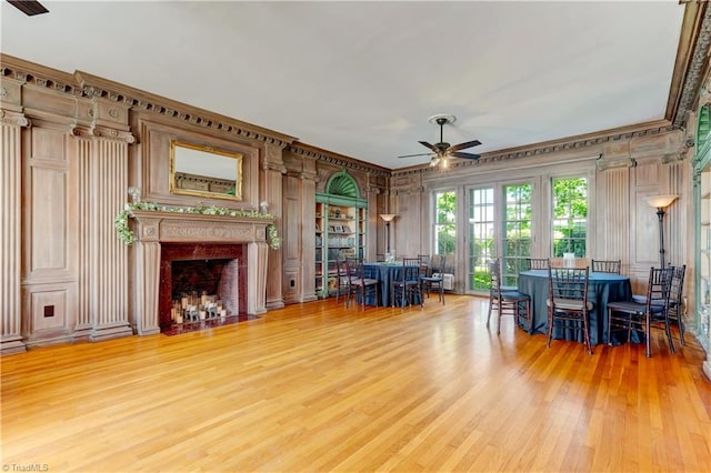 17 E Main St, Thomasville, NC 27360 - living area featuring a ceiling fan, light wood-style flooring, a fireplace with flush hearth, and ornamental molding