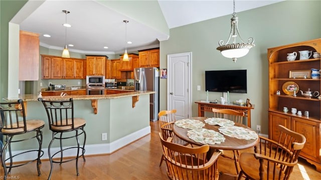 dining room with recessed lighting, ornamental molding, baseboards, light wood-type flooring, and lofted ceiling