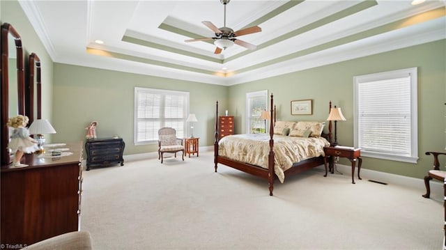 bedroom featuring ornamental molding, baseboards, a raised ceiling, and carpet floors