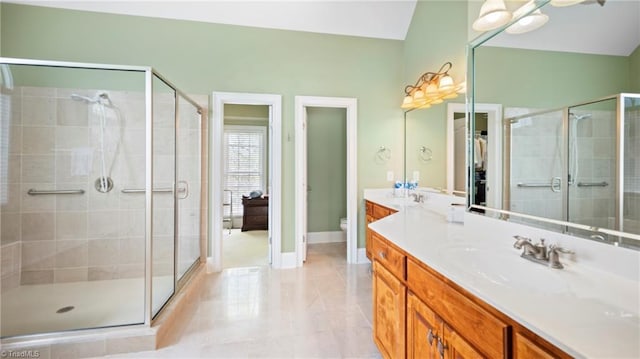 bathroom featuring a shower stall, baseboards, toilet, vaulted ceiling, and vanity