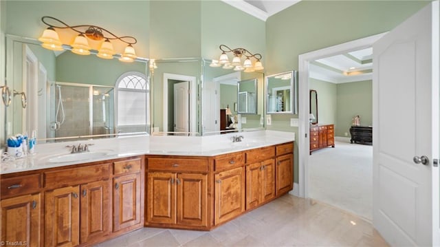 full bath featuring double vanity, a shower stall, ornamental molding, and a sink