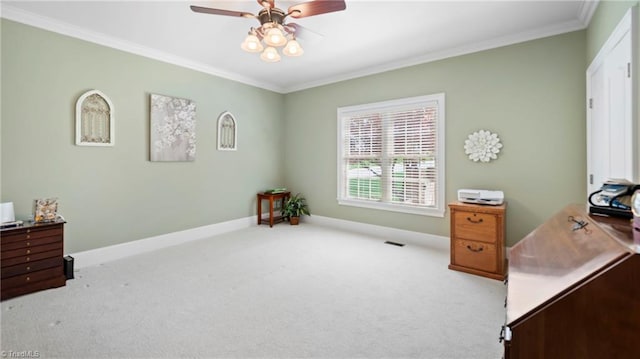 carpeted office featuring baseboards, visible vents, a ceiling fan, and crown molding