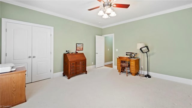 carpeted bedroom with ornamental molding, a ceiling fan, a closet, and baseboards