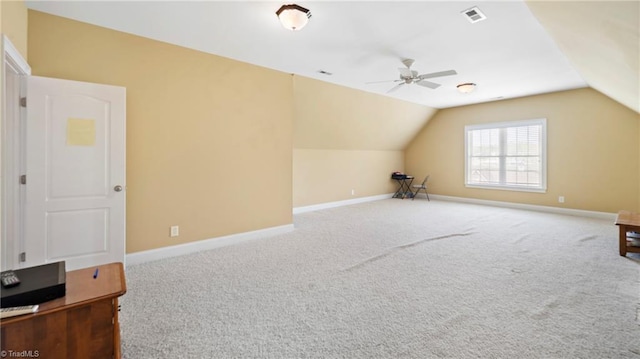 additional living space featuring visible vents, a ceiling fan, lofted ceiling, and carpet