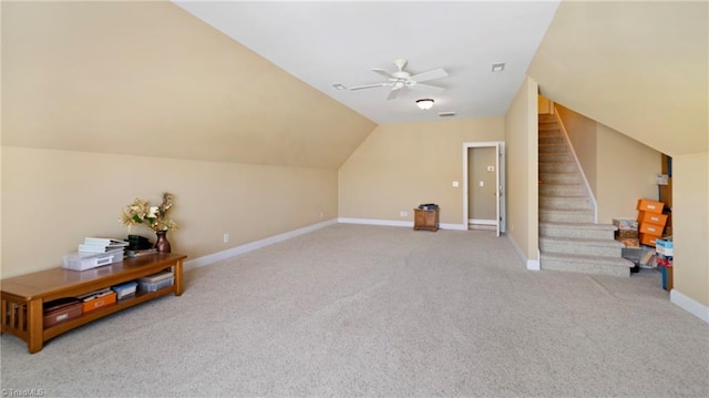 bonus room with carpet floors, vaulted ceiling, ceiling fan, baseboards, and stairway