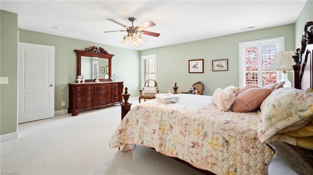 carpeted bedroom featuring a ceiling fan and baseboards