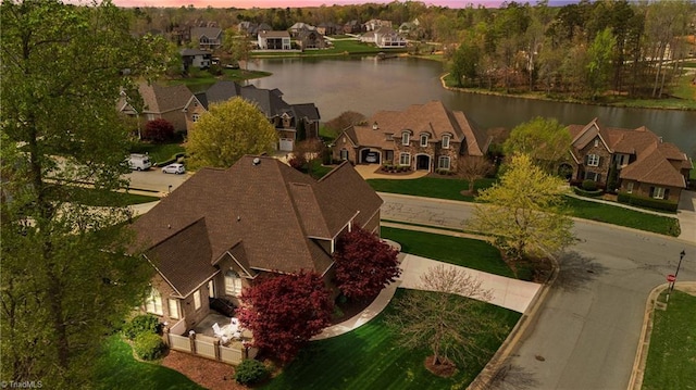 birds eye view of property featuring a residential view and a water view