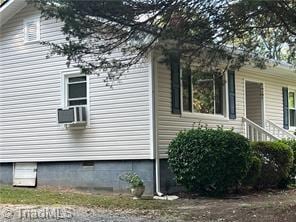 view of side of property with cooling unit