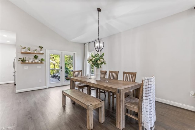 dining room with high vaulted ceiling, an inviting chandelier, french doors, and dark hardwood / wood-style floors