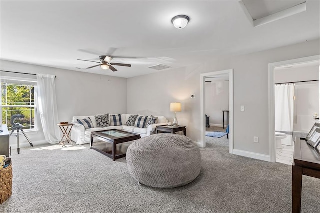 living room with ceiling fan and carpet floors