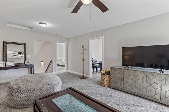 living room featuring ceiling fan and carpet